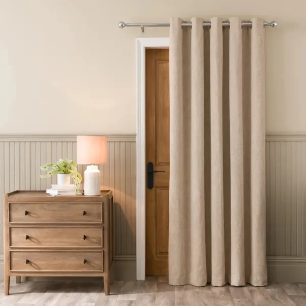 Beige curtain covering door in cozy bedroom corner Dubai