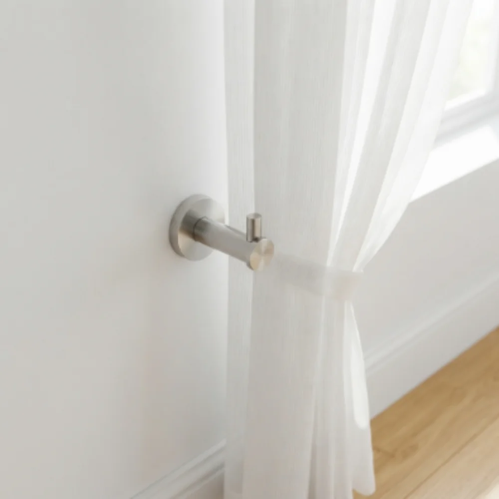 Elegant curtain hooks holding sheer white curtains for bright spaces