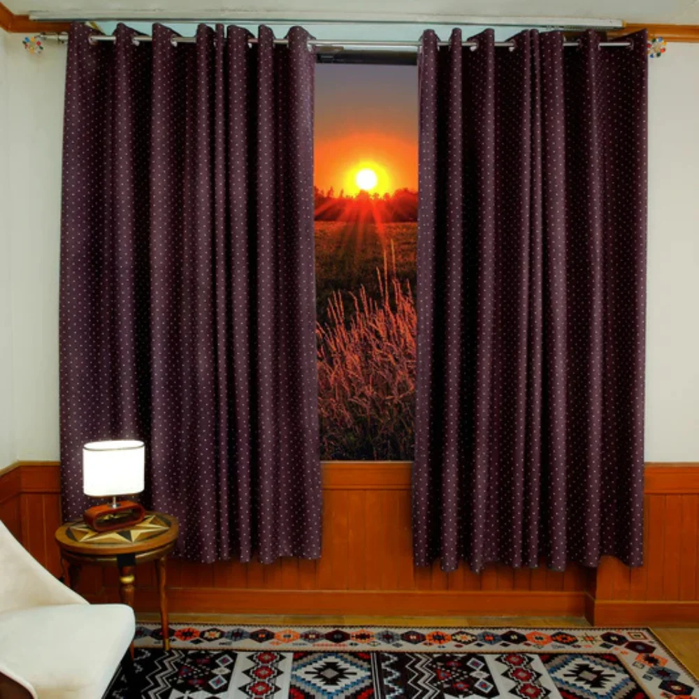 Maroon patterned curtain framing bedroom window at sunset