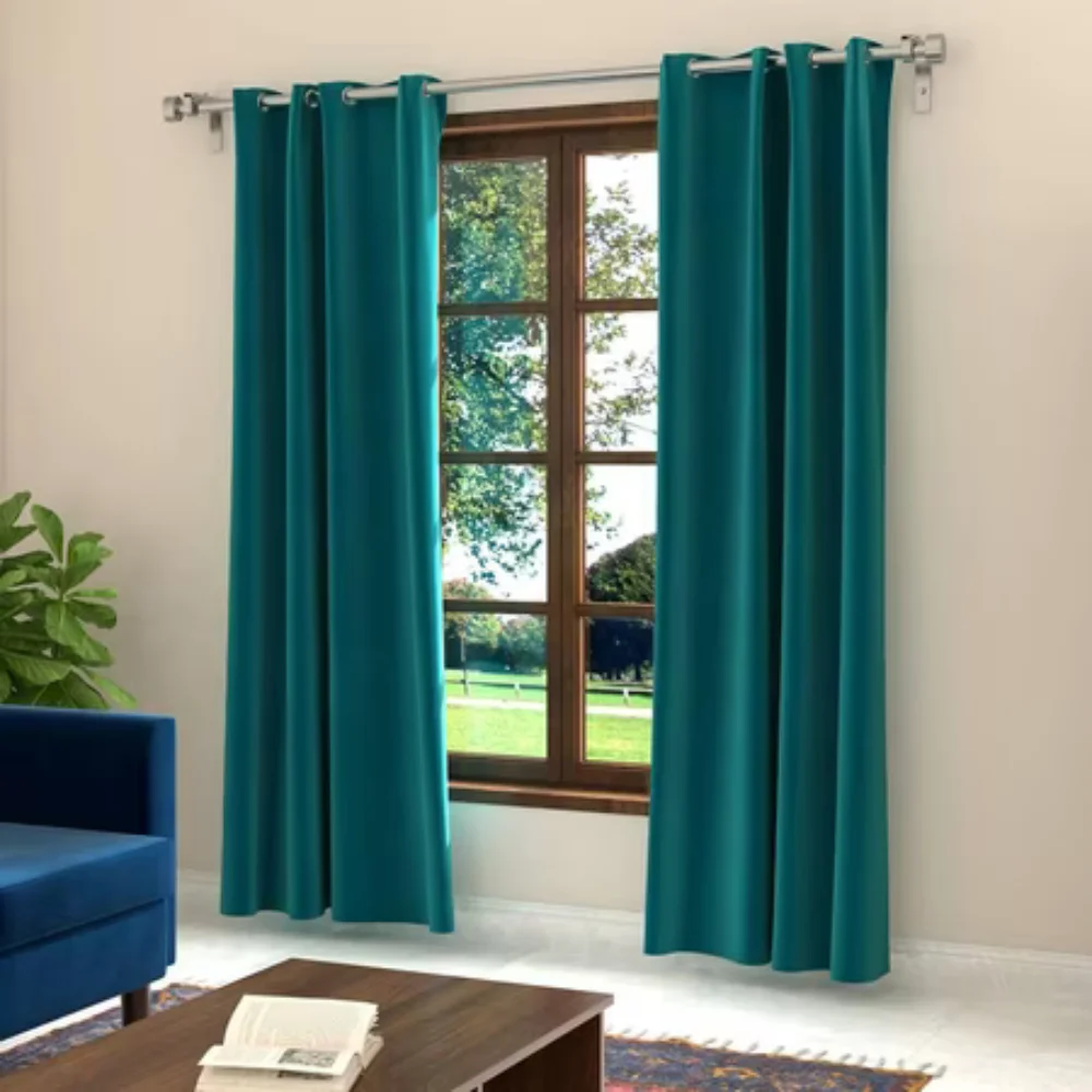 Teal green curtain framing large window in living room